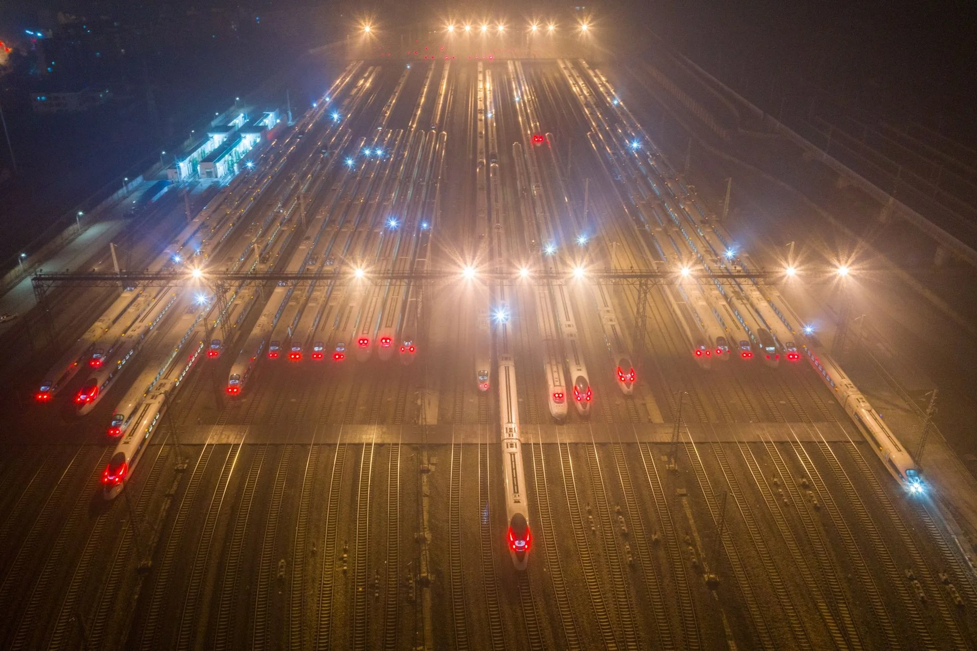 A high-speed train running through the Chinese countryside past green hills