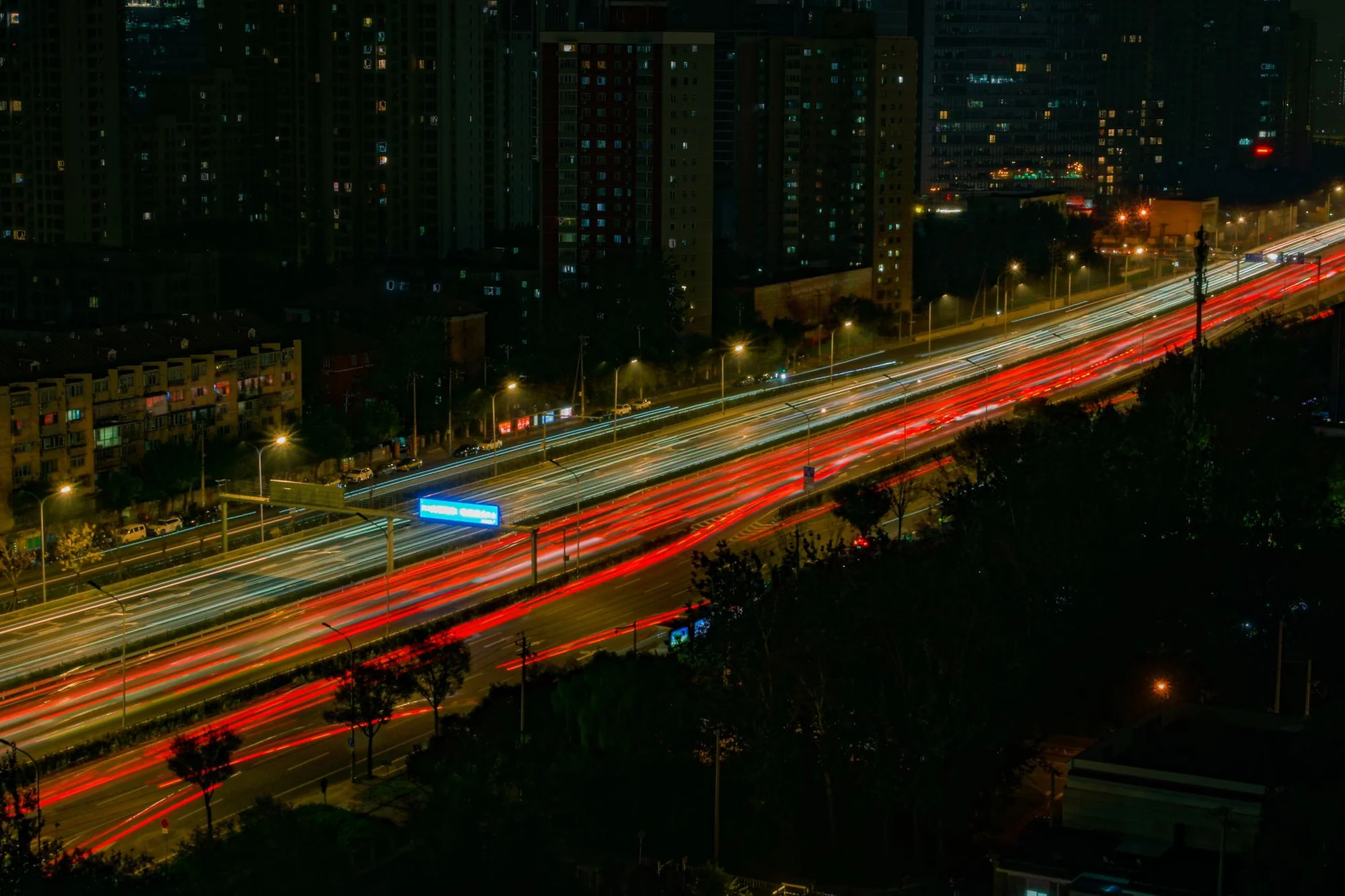 Long-exposure light trails on a Chinese city highway at night