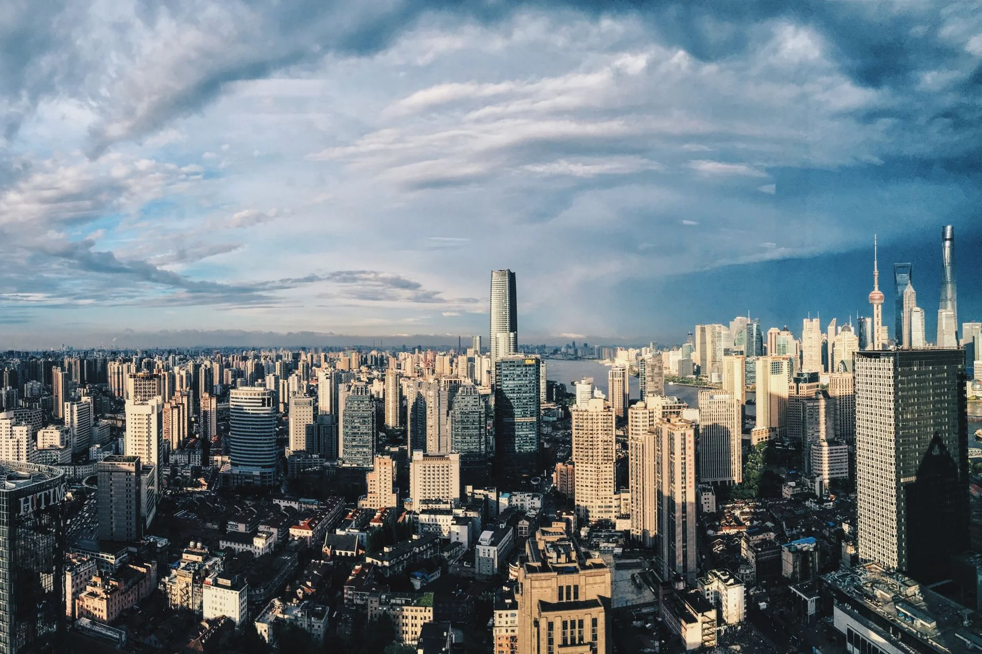 Aerial panorama of Shanghai's modern skyline, including the Oriental Pearl Tower and the Pudong skyscrapers
