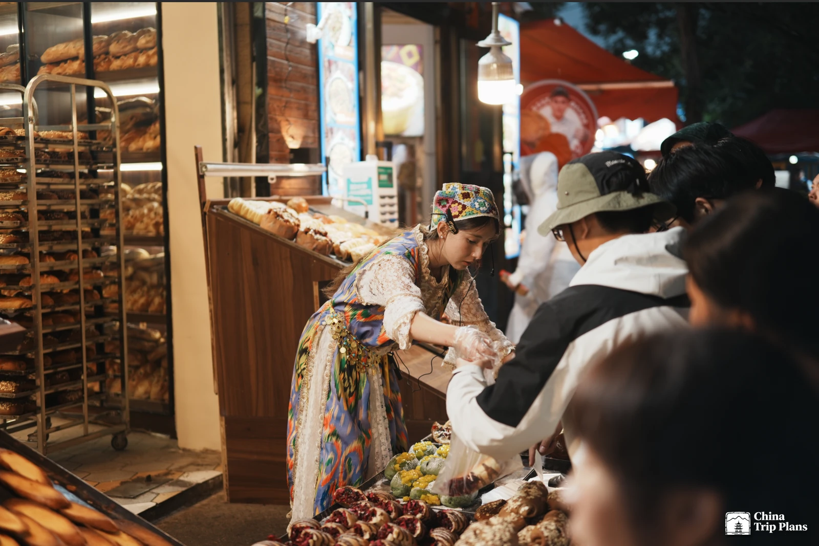 A vendor serves food at a Chinese night market stall
