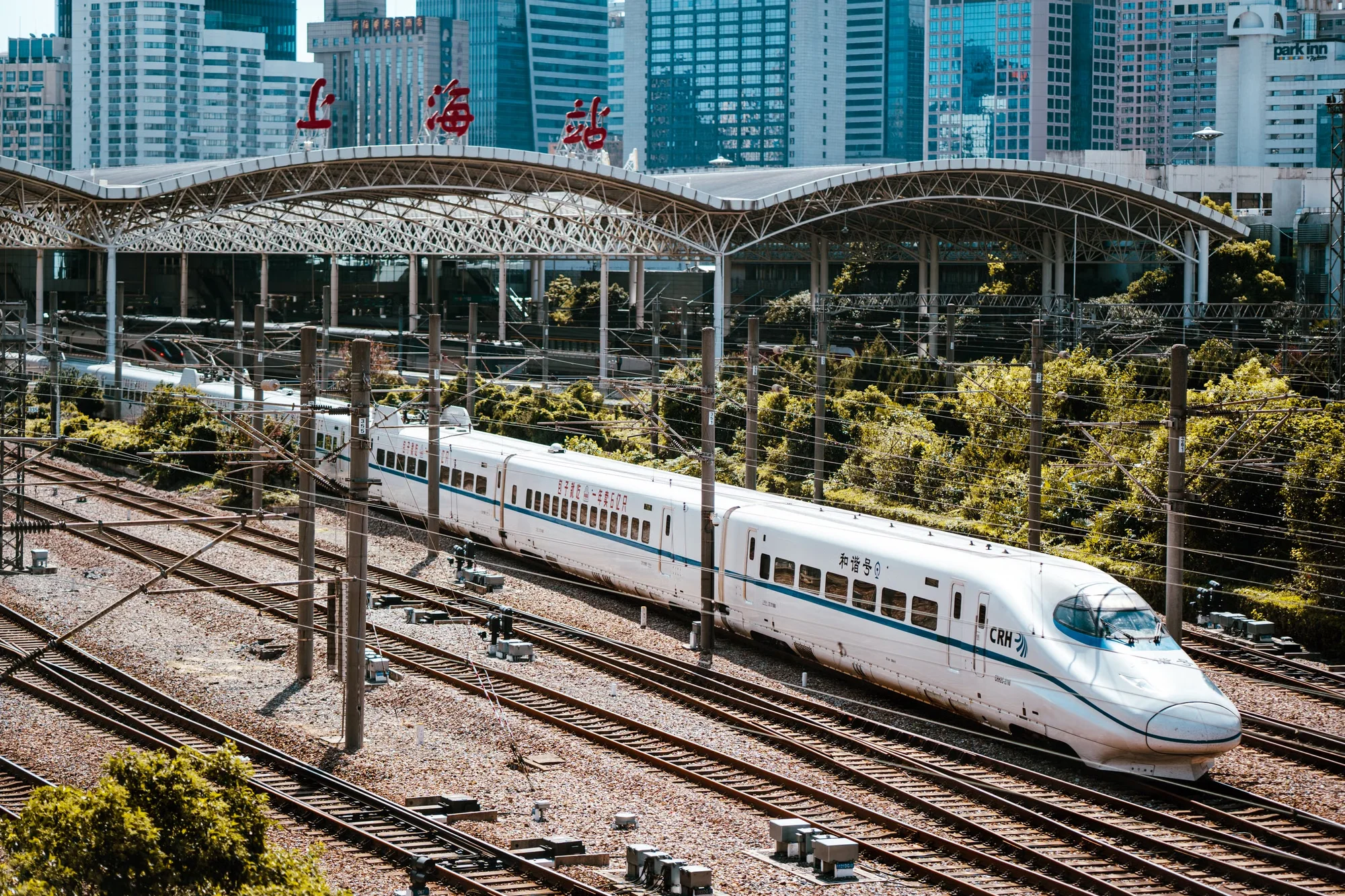 A high-speed train platform with a sleek white bullet train at a station in China