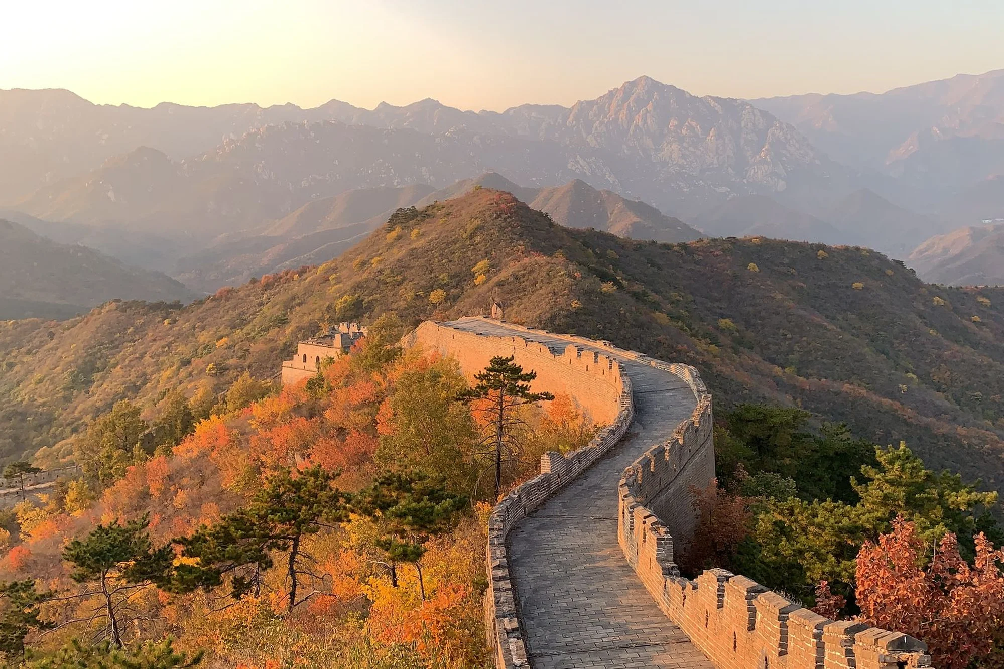 The Great Wall of China following mountain ridges at sunrise