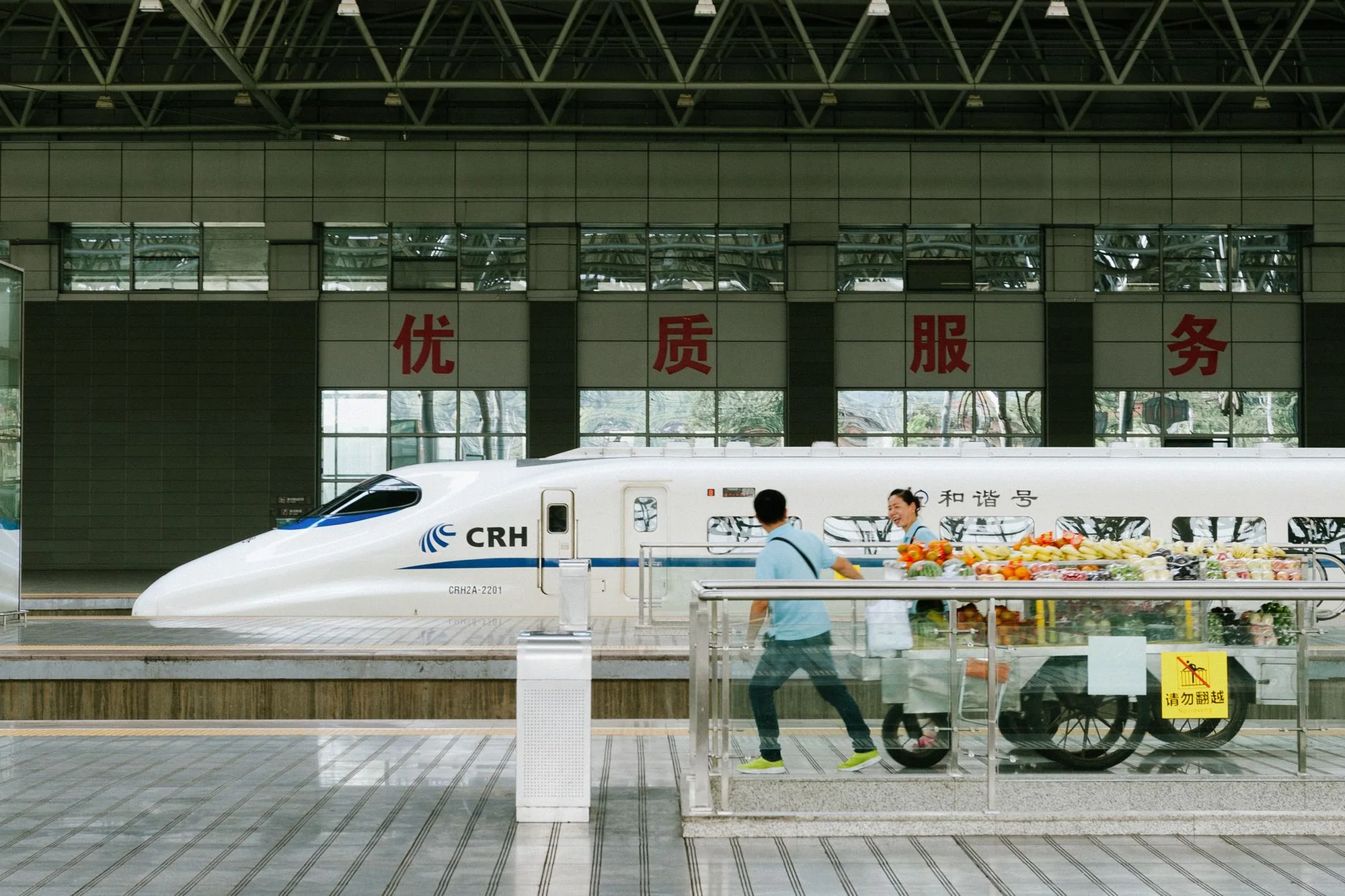 A busy departure board listing train services at a Chinese railway station