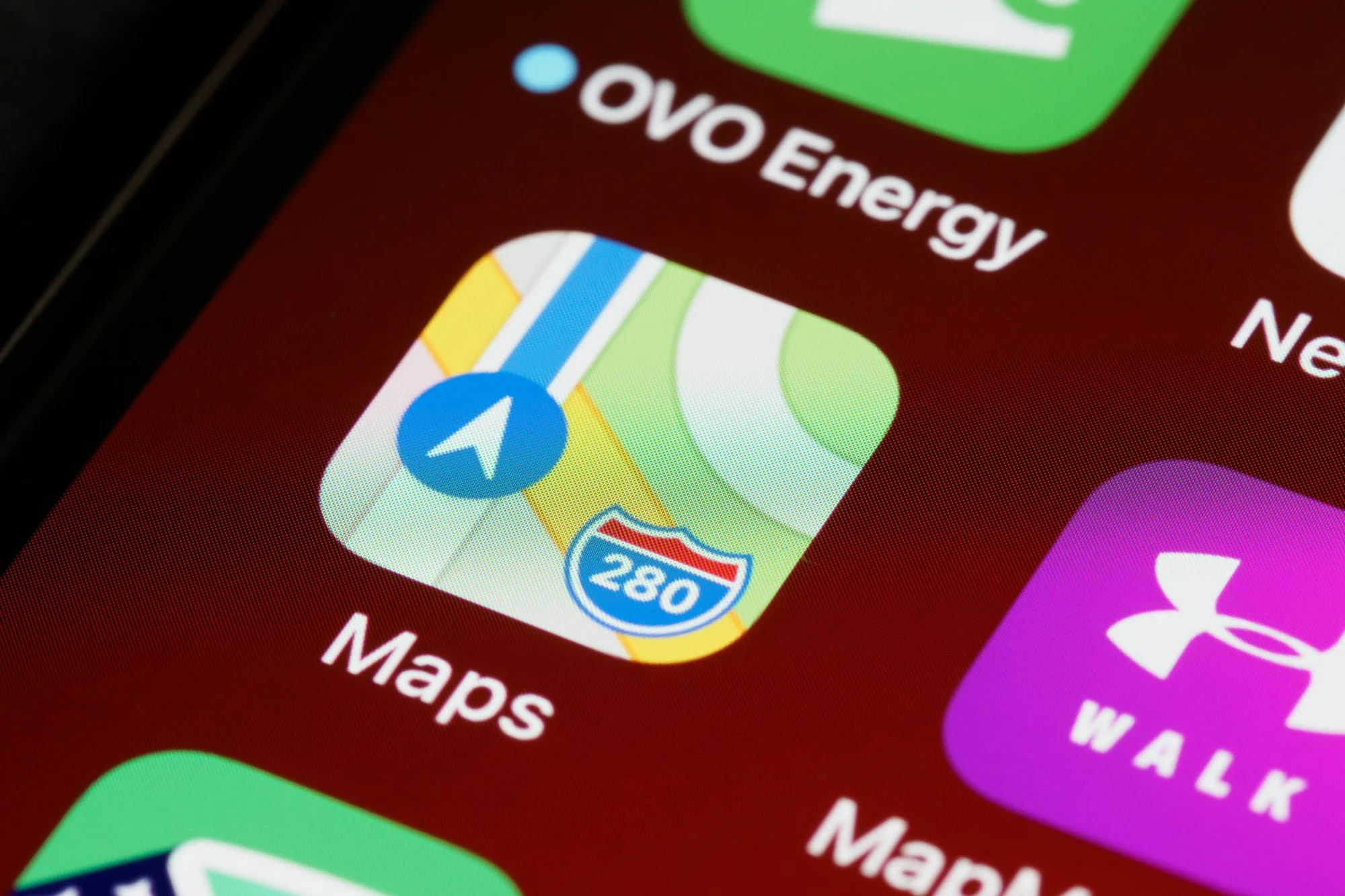 A maps app icon on a smartphone screen next to other apps