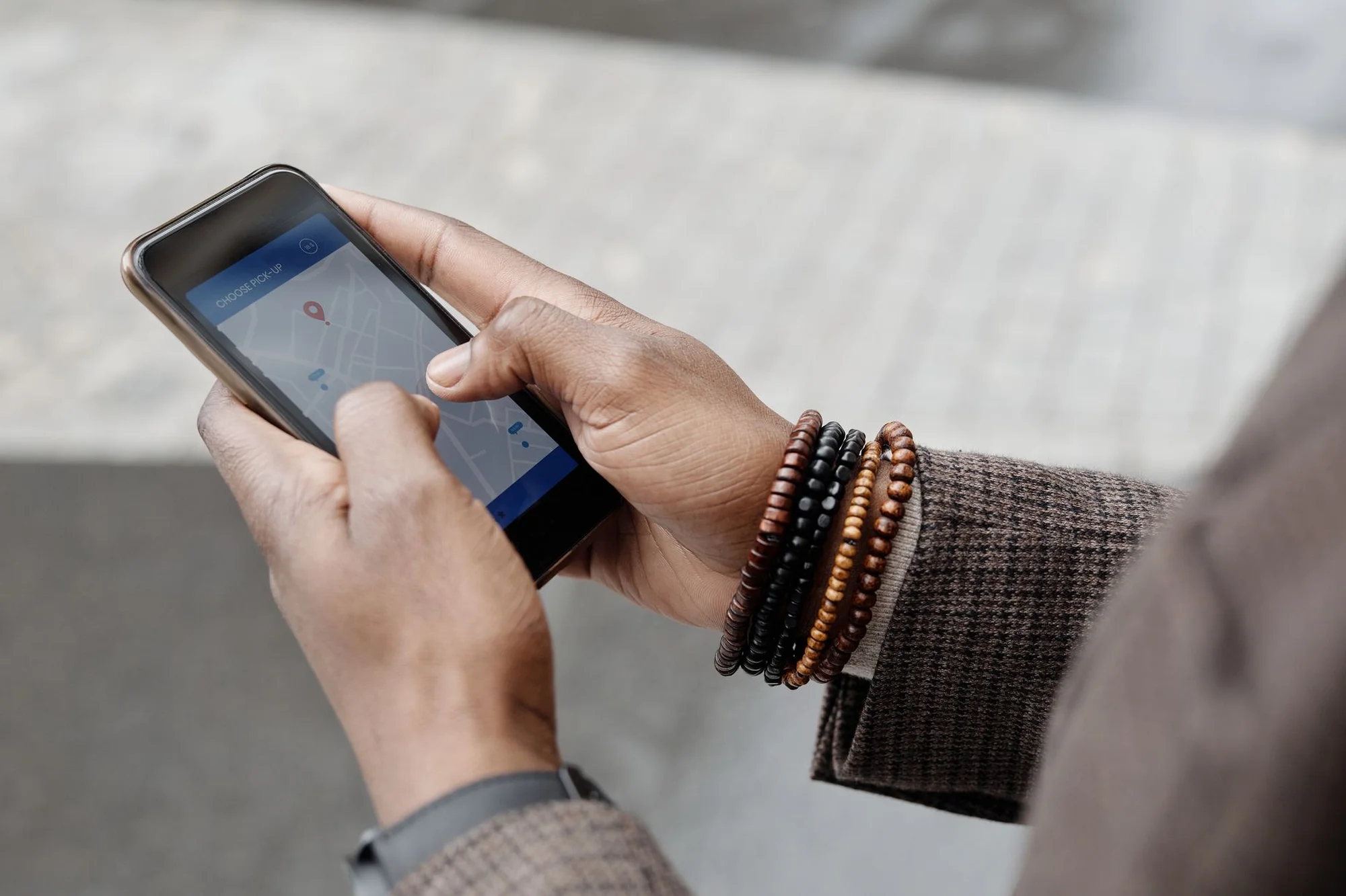 A traveler using a maps app on a smartphone to find a destination
