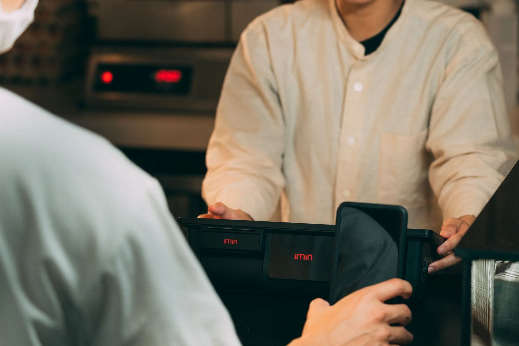 A customer scanning a QR code to pay at a Chinese restaurant