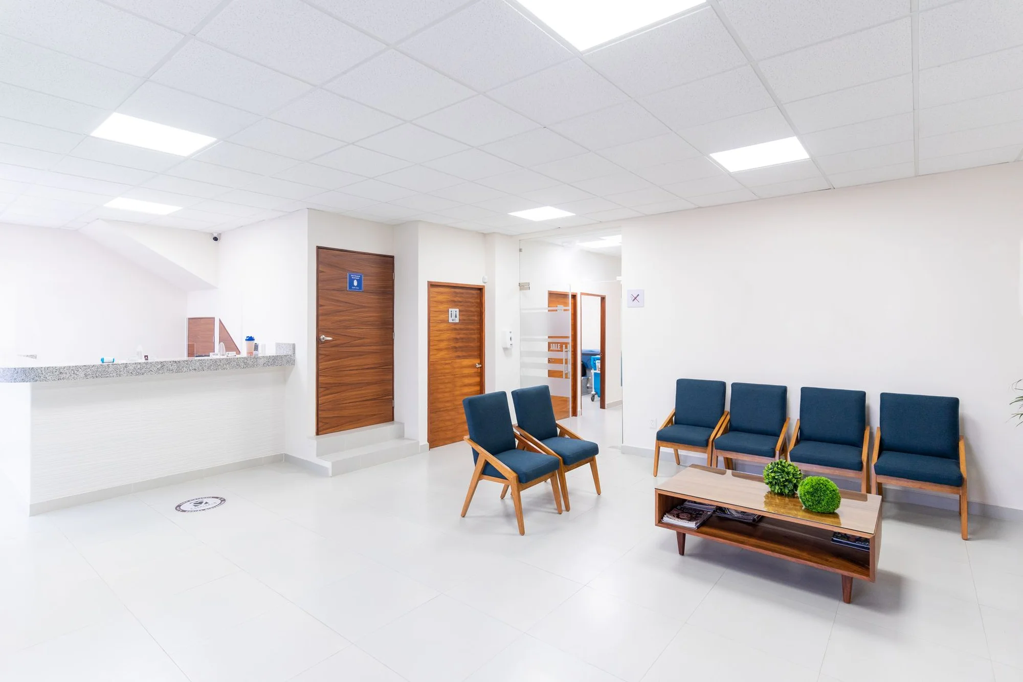 A calm hospital lobby with seating and clear signage in China