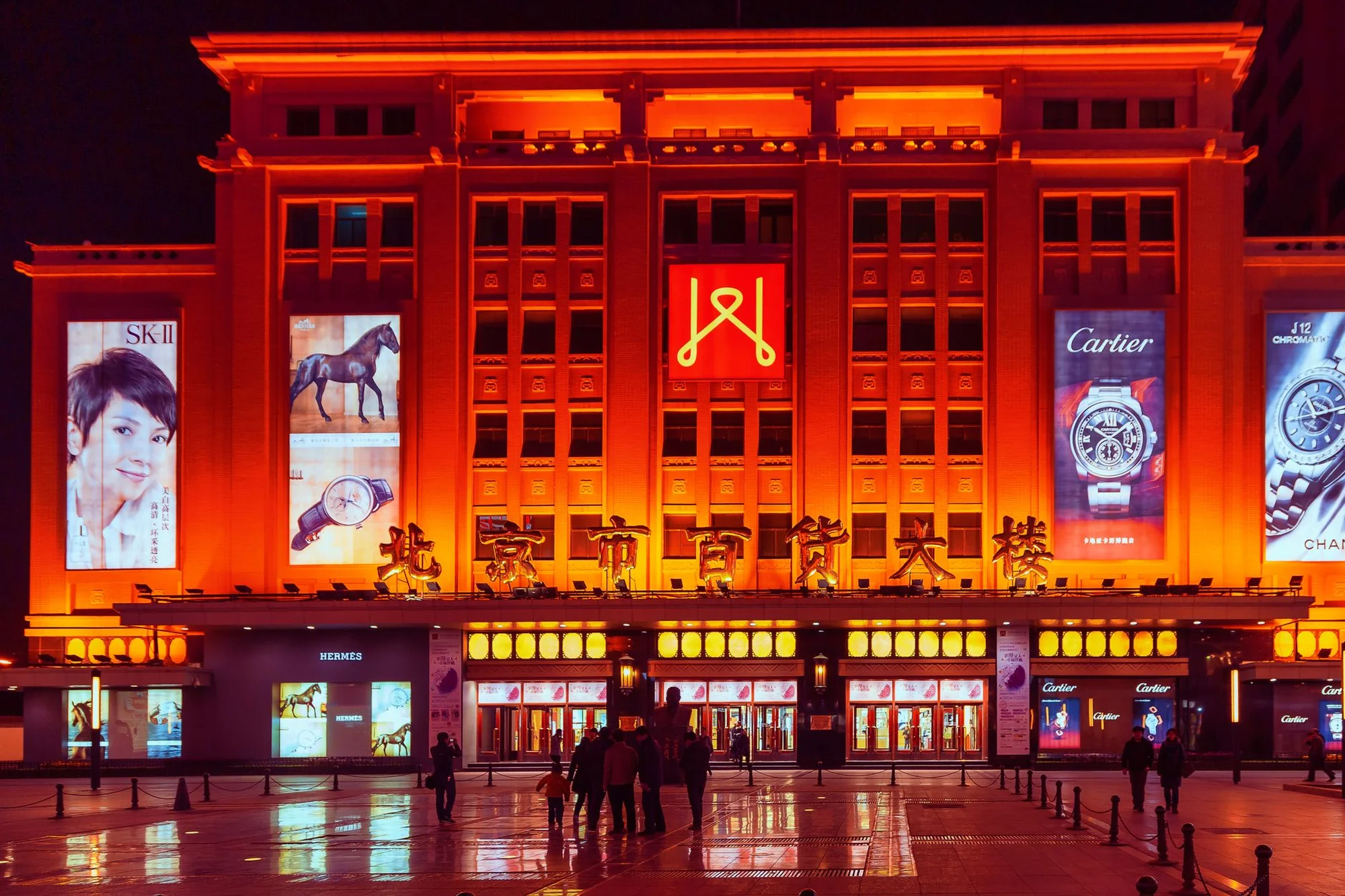 A Chinese shopping street with hanging shop signs, parked scooters and Chinese characters on storefronts