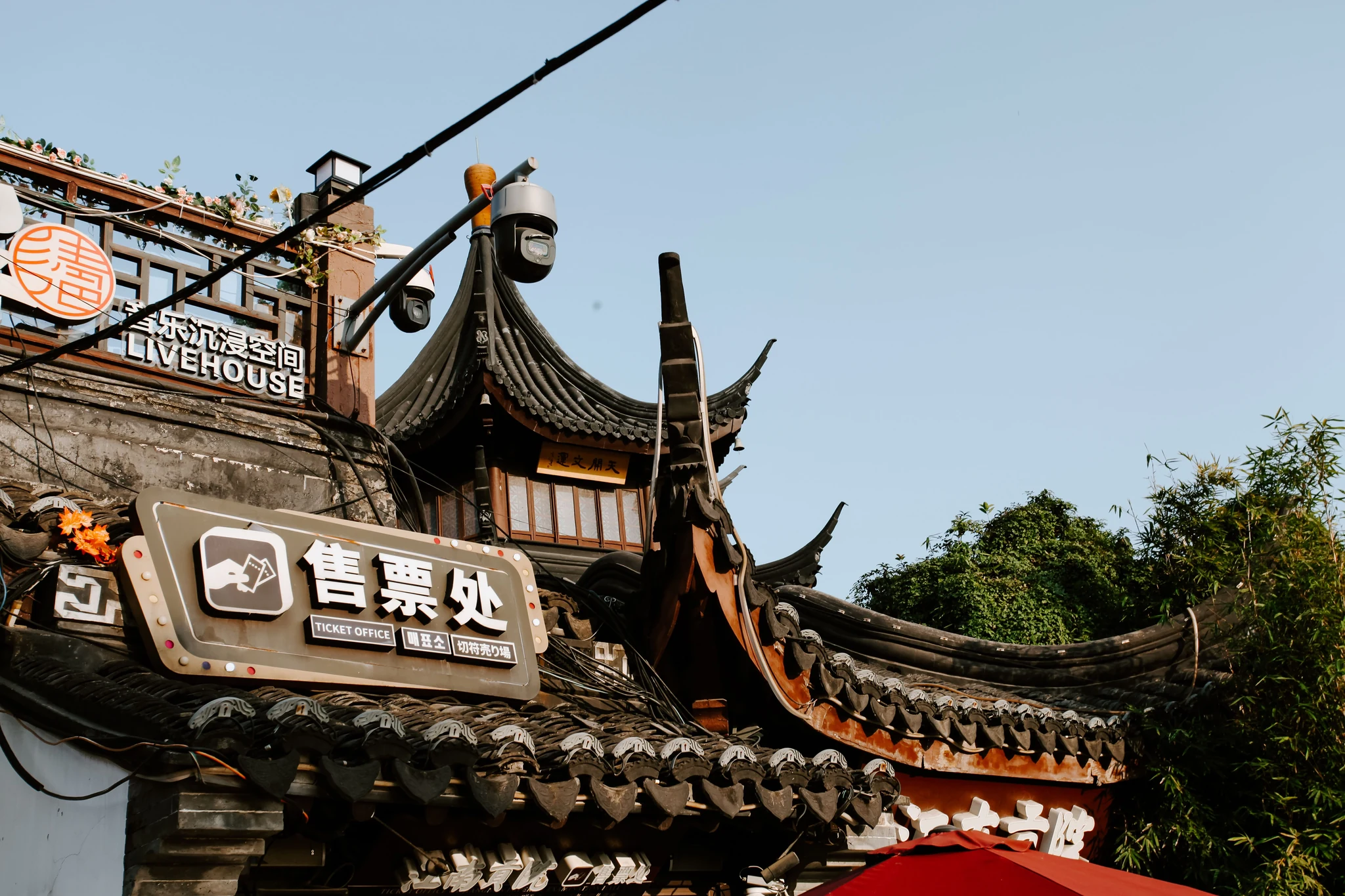 A traditional Chinese ticket-office sign for an attraction, with a curved tile roof and a camera above, indicating the only place tourists should buy tickets