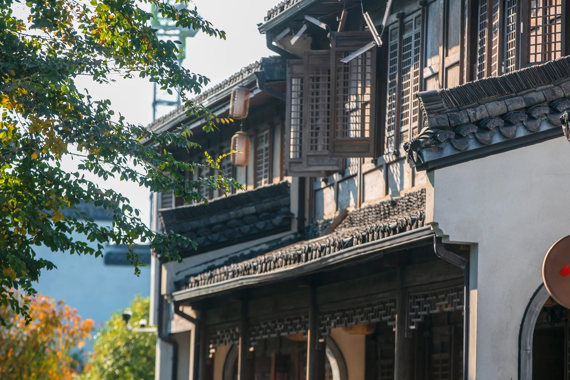 A traditional Chinese building with ornate roof tiles and wooden lattice windows, the kind of scene found in old towns across the country