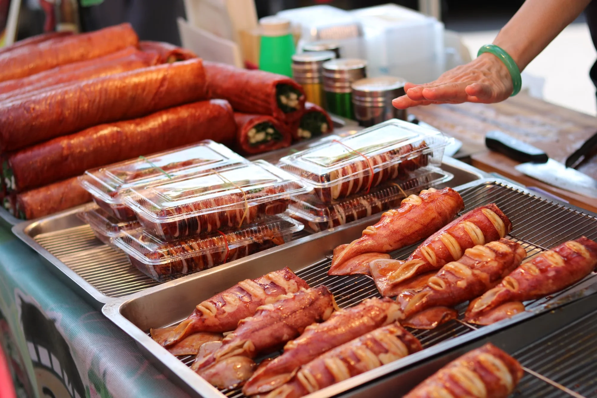 Busy street food stall with grilled seafood skewers at a Chinese market