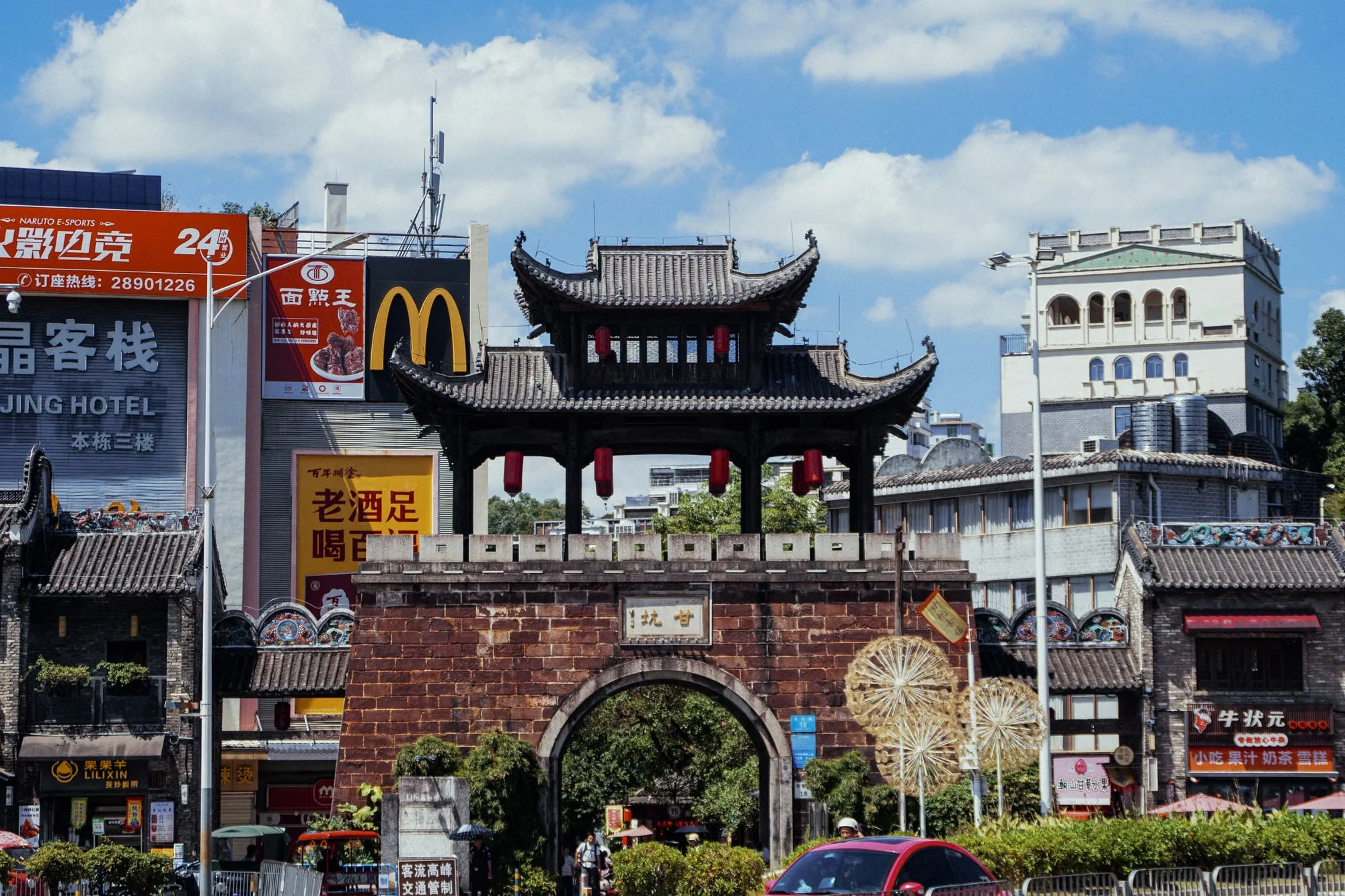 A friendly safety-and-ease overview of China 2026: a calm night-market scene with a solo traveler using a phone, a metro sign in English and Chinese, and a small "low crime" icon