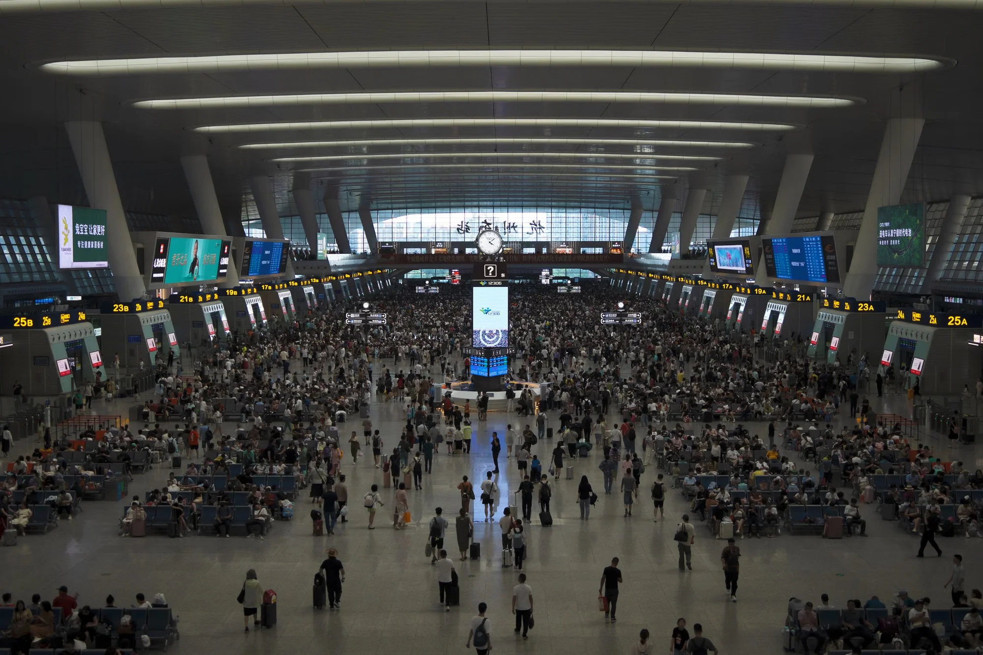 Passengers in the waiting hall of a busy Chinese railway station