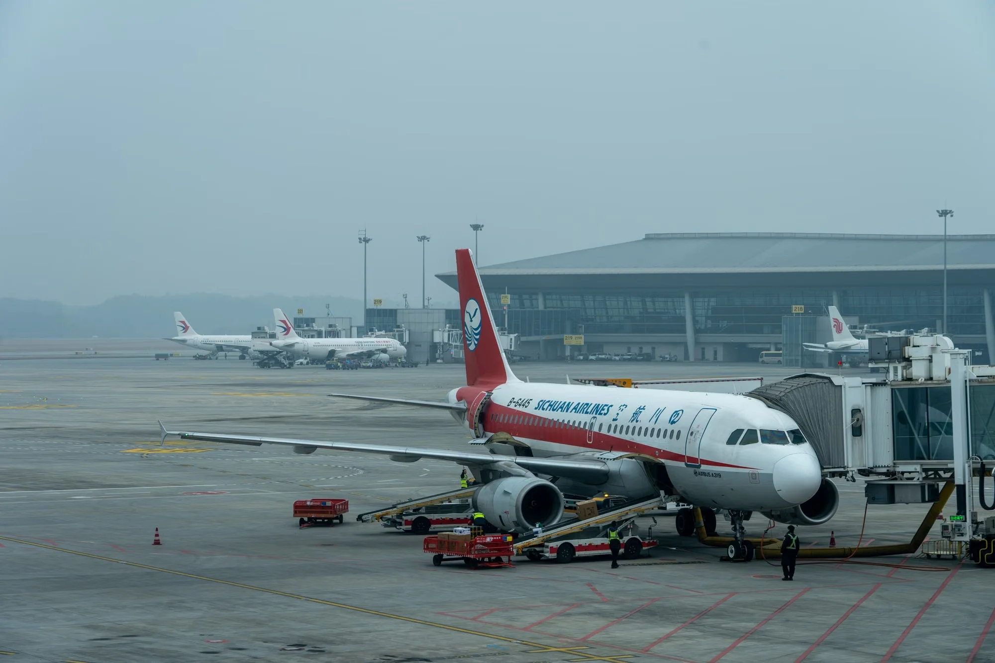 Sichuan Airlines aircraft parked at a Chinese airport gate