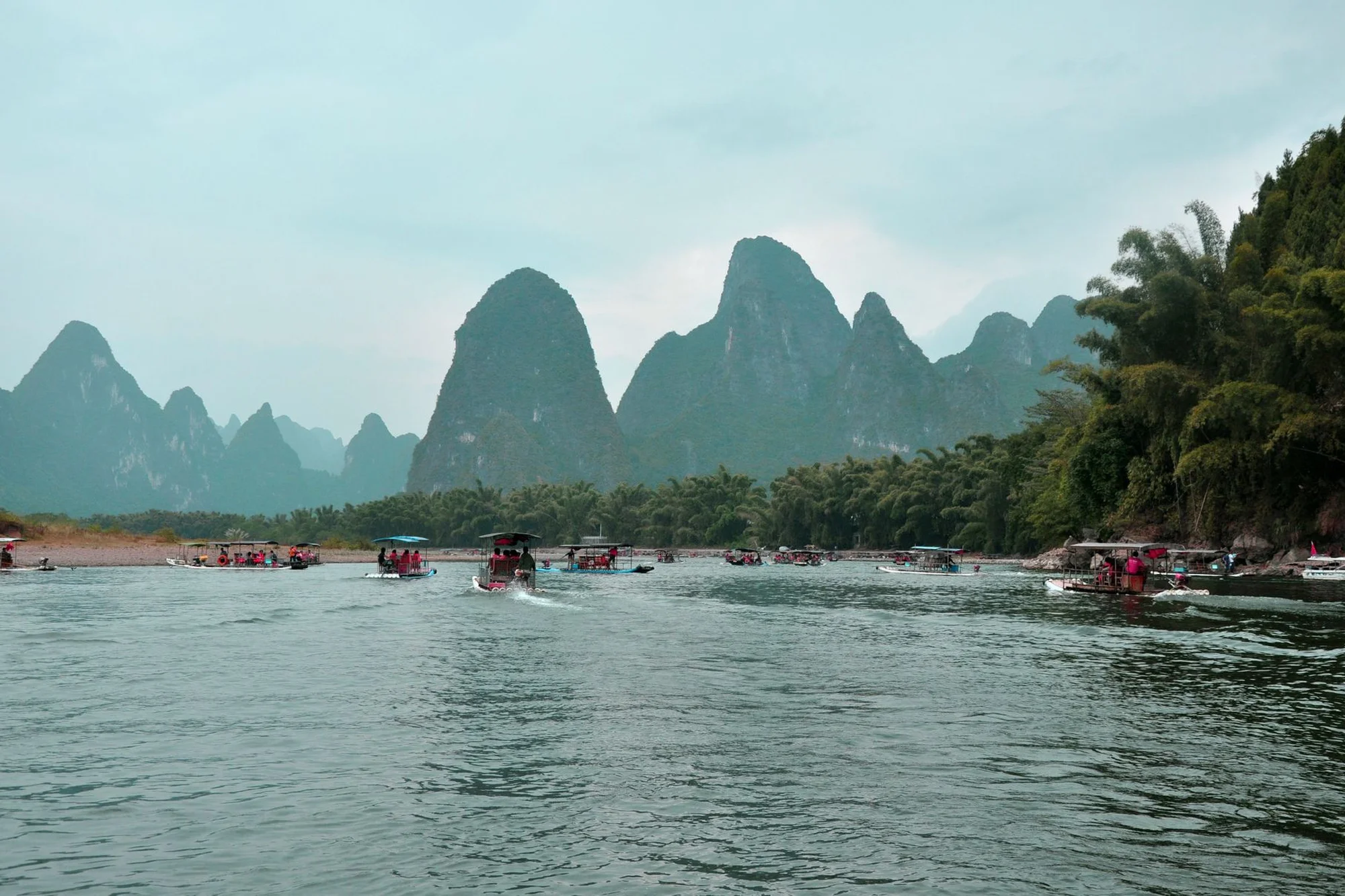 A traditional boat on the Li River with Guilin's karst peaks reflected in calm water
