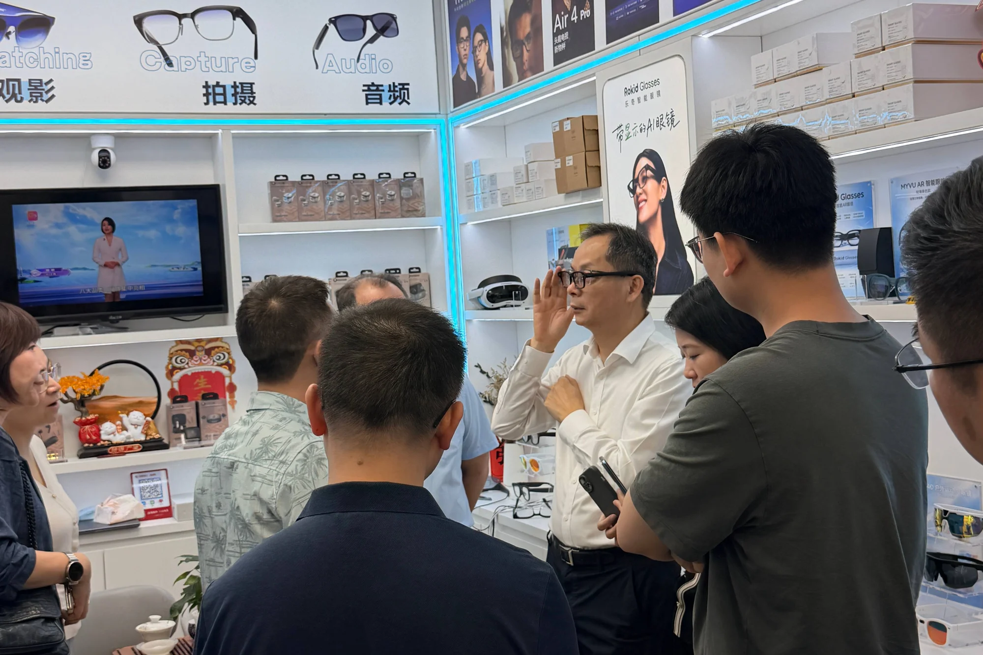 A smart-glasses showroom crowded with customers inside Shenzhen's Huaqiangbei electronics district