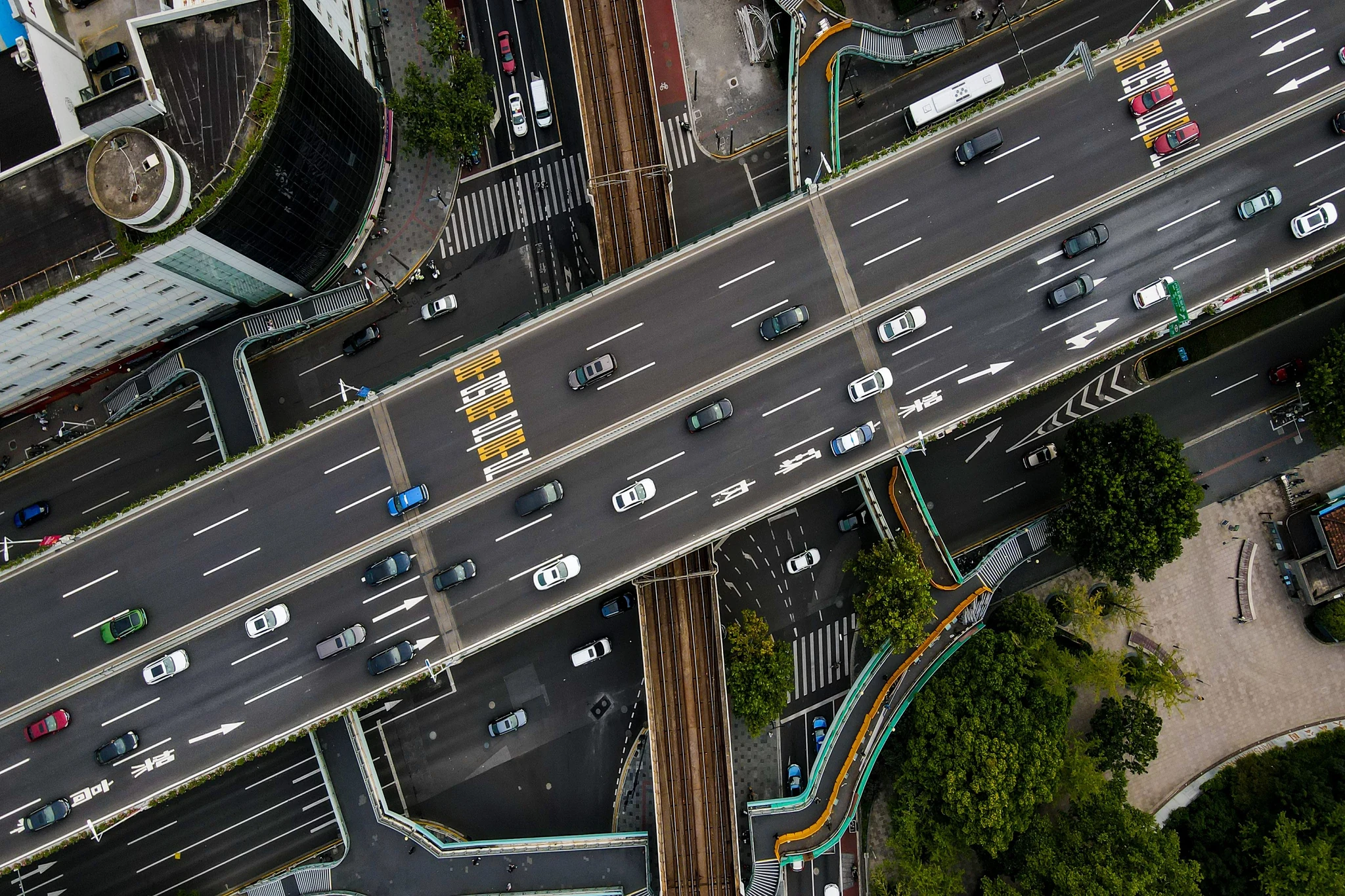 An aerial view of a busy multi-lane Chinese city elevated highway with dense traffic, lane markings in Chinese and clear painted directional arrows