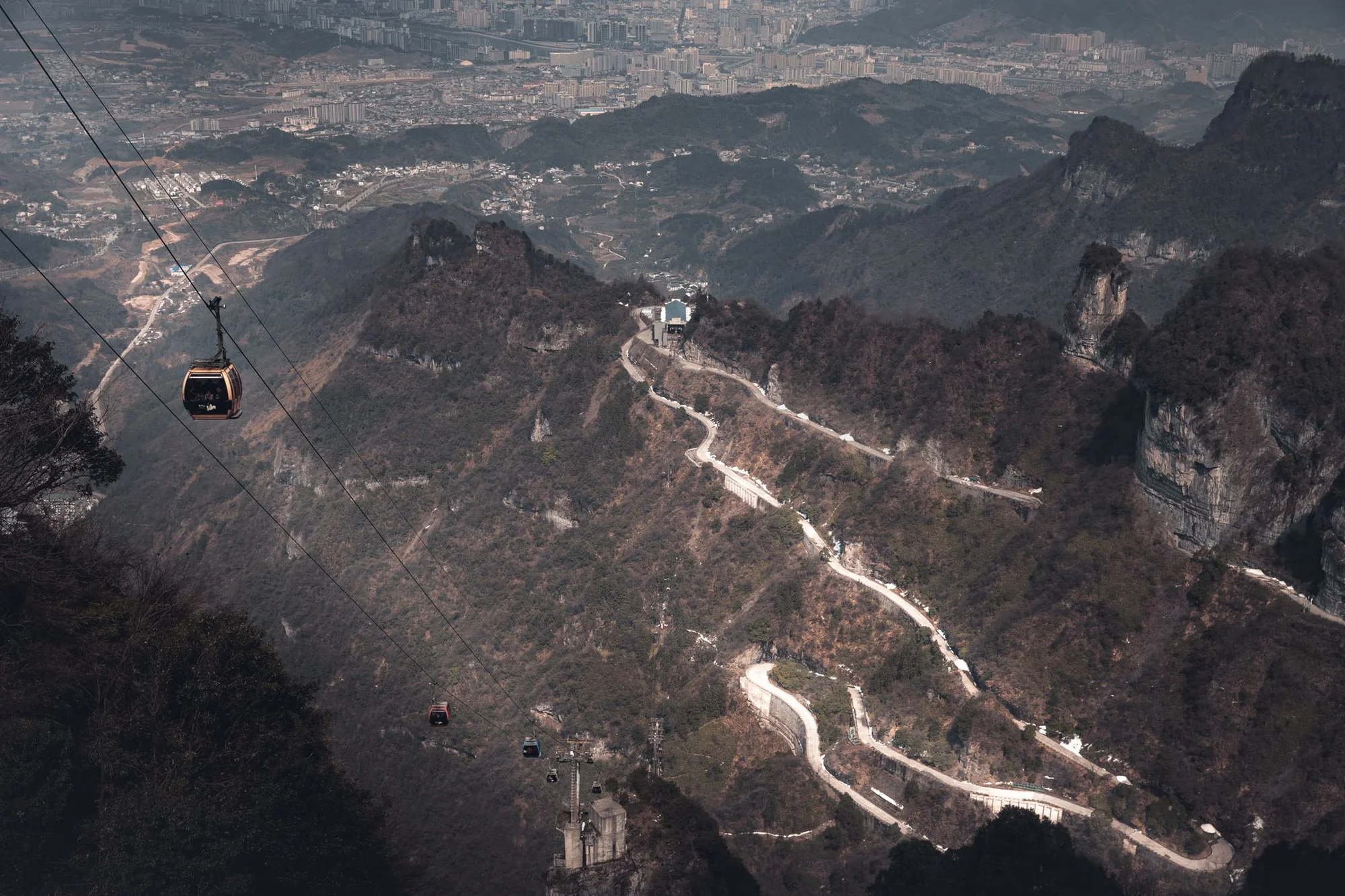 The Tianmen Mountain cable car climbing above the winding mountain road